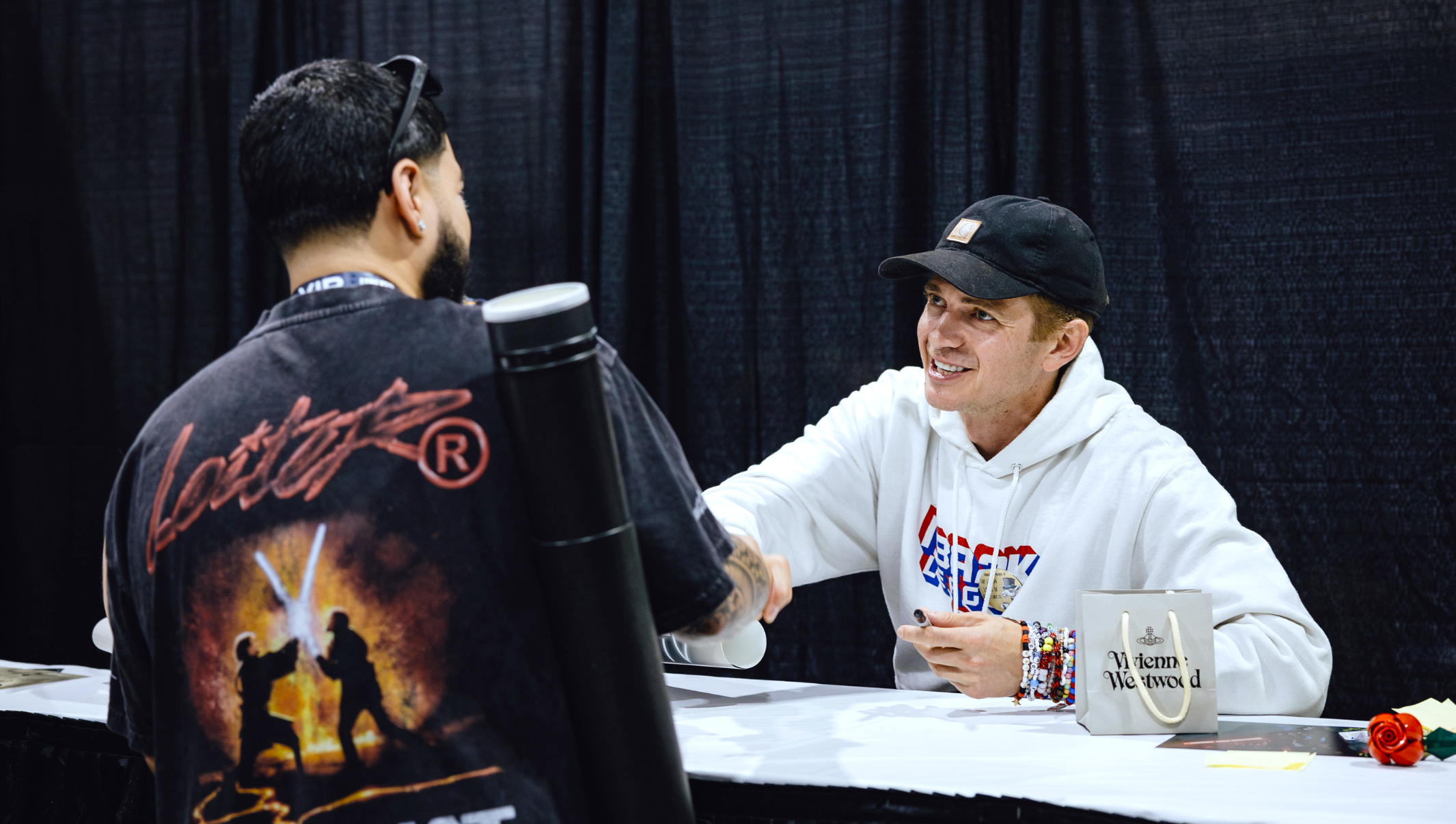 Actor Hayden Christensen meeting a fan in a Star Wars jacket.