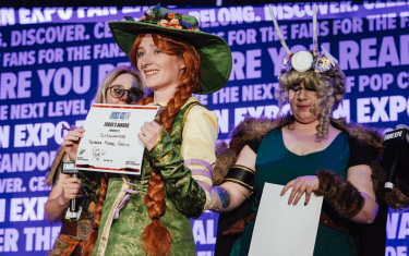 A woman cosplaying as Professor Mirabel Garlick with her "Judge's Award" at the Cosplay Craftsmanship Cup.
