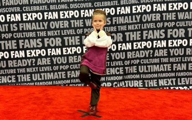 A young girl cosplaying as Princess Leia posing on the Cosplay Red Carpet.