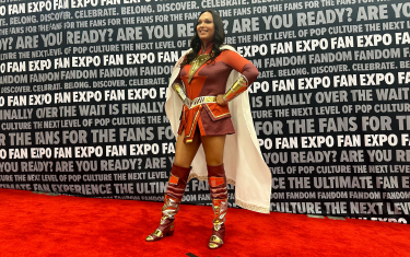 A woman cosplaying as Shazam! posing on the Cosplay Red Carpet.