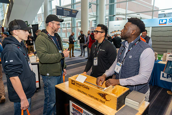 Attendees Interacting at Booth