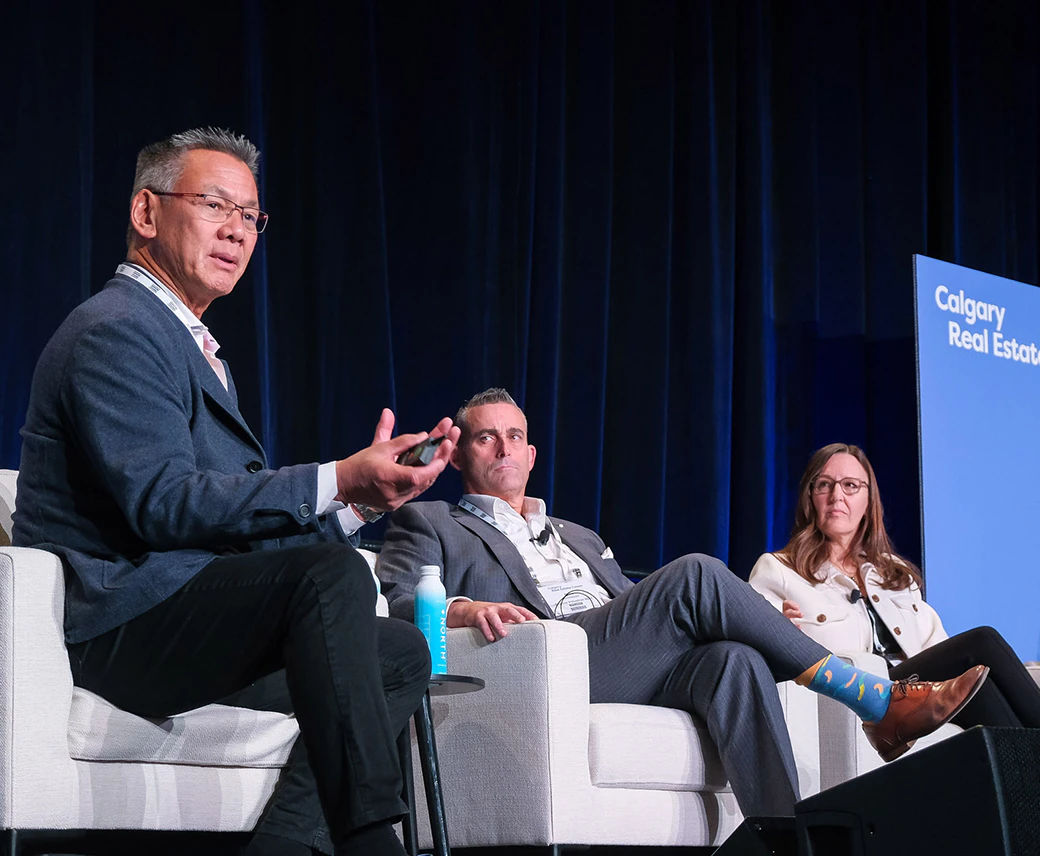 three speakers on the Calgary Real Estate Forum stage