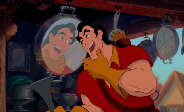 In a pan, Gaston checks his appearance to show his vanity.