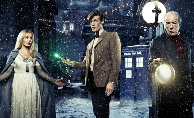 Abigail, Kazran, and the Doctor stand in a snowy alley - the TARDIS is lit up behind them
