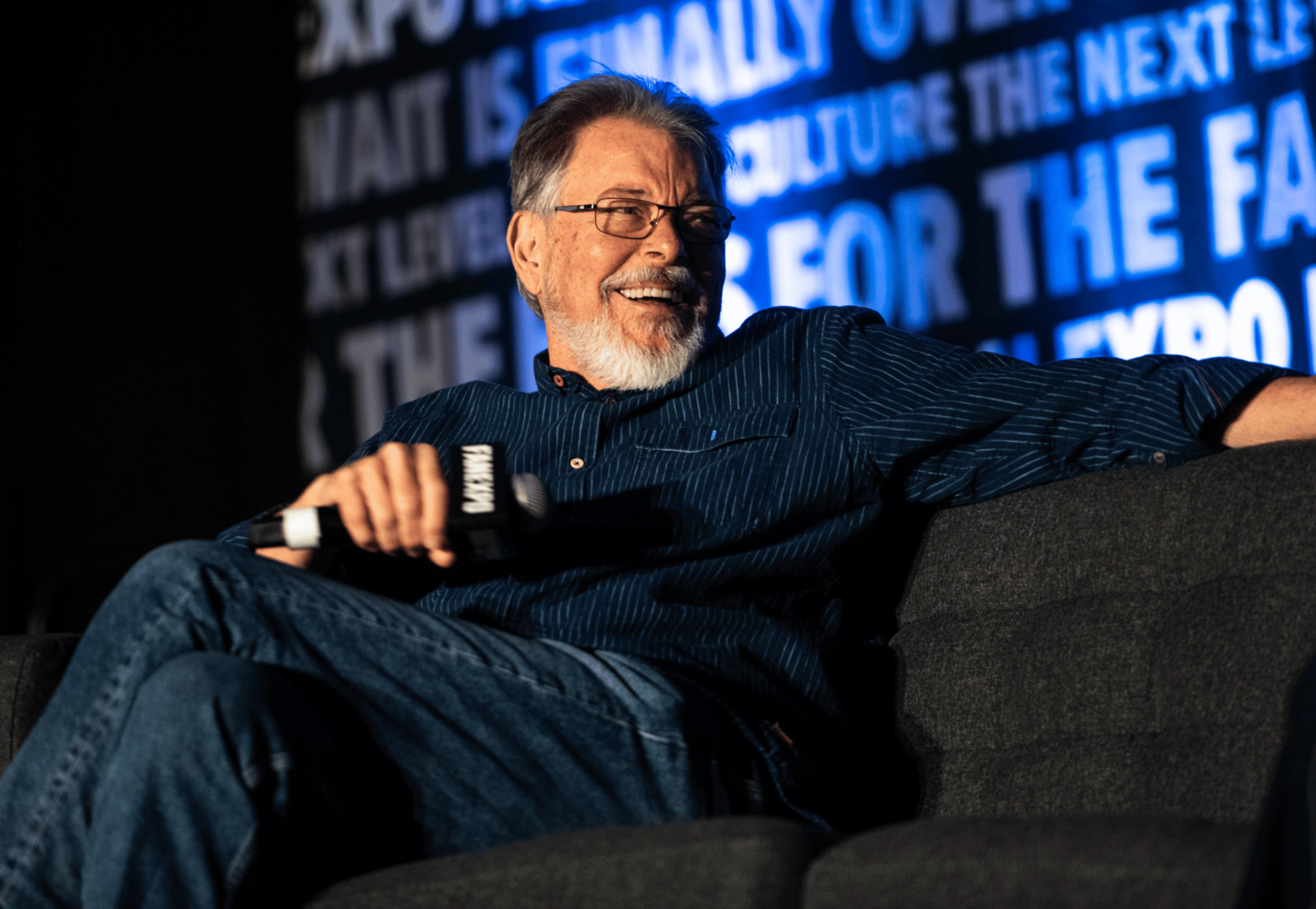Zachary Levi standing and speaking into microphone at celebrity guest panel