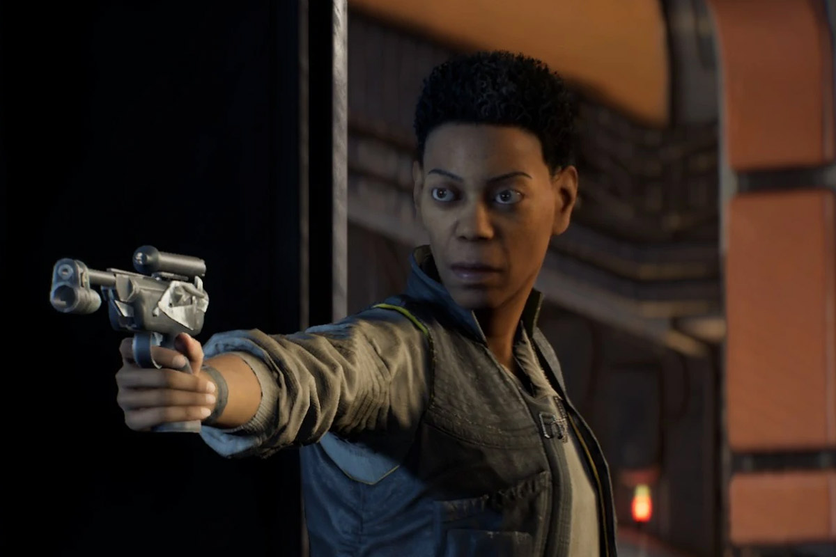Cere Junda wearing a black vest and grey shirt points a blaster at something off screen