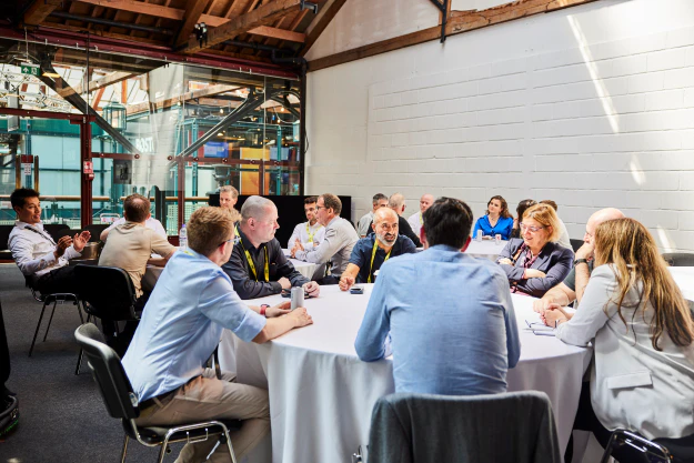 Attendees discuss challenges in a game at The AI Summit London