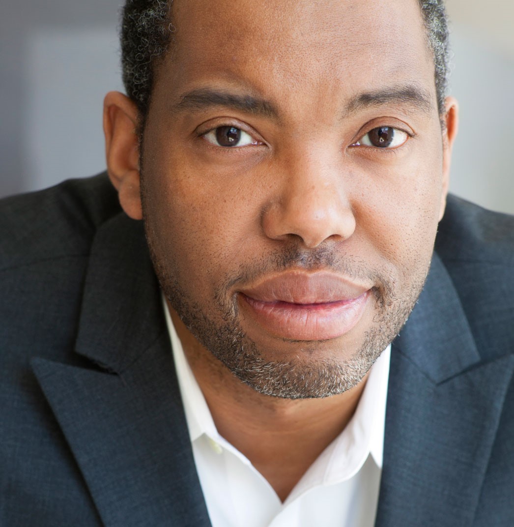 Ta-Nehisi Coates in a dark grey suit jacket and white collared shirt