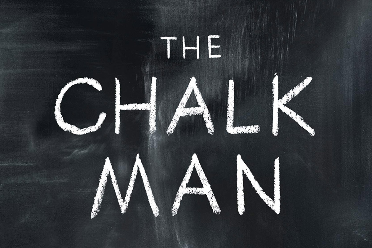 A chalkboard with the words "THE CHALK MAN" written across