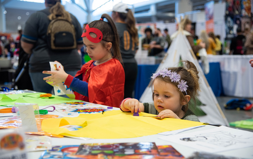 two young girls drawing and crafting in the family zone