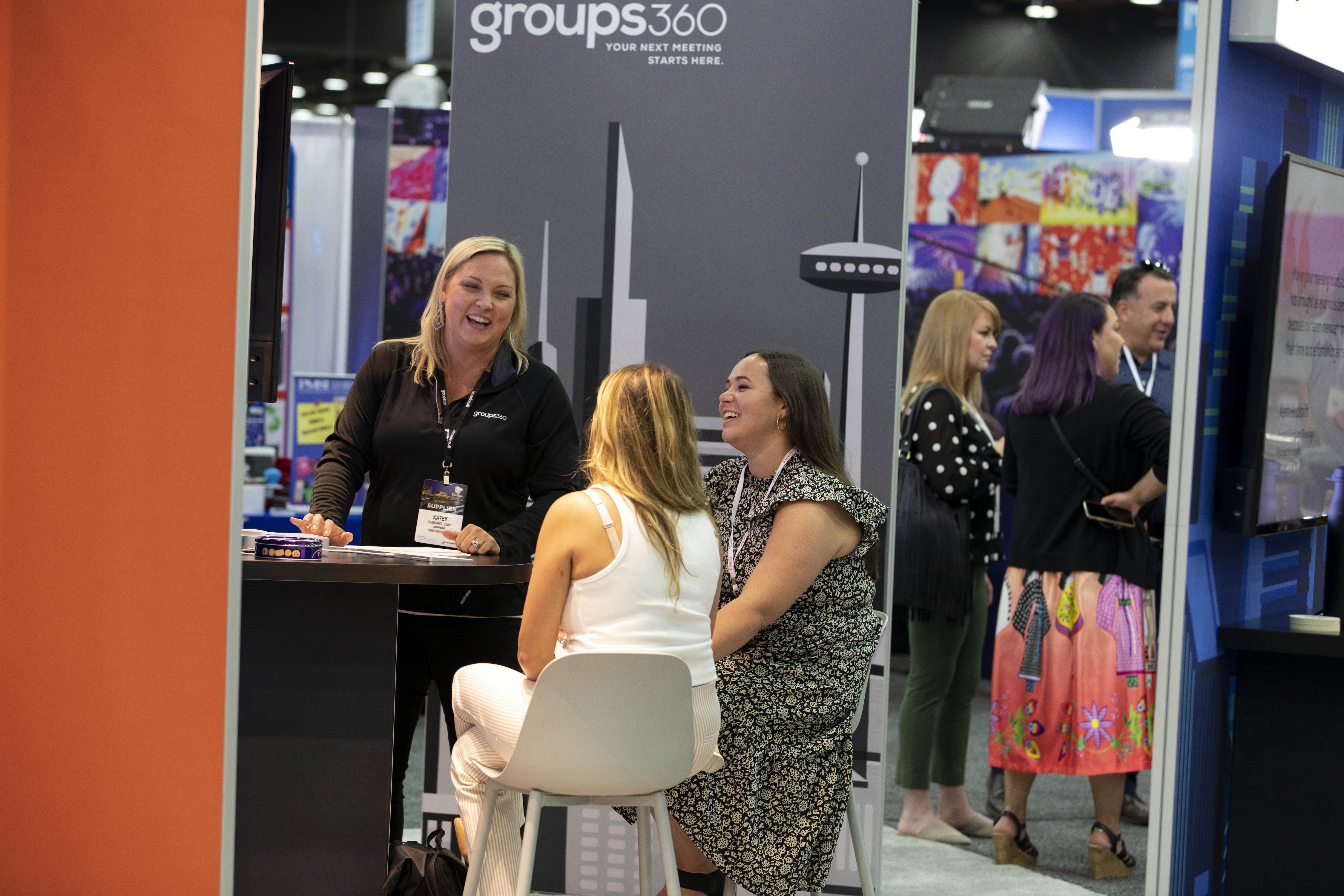 An exhibitor conducting a meeting in her trade show booth