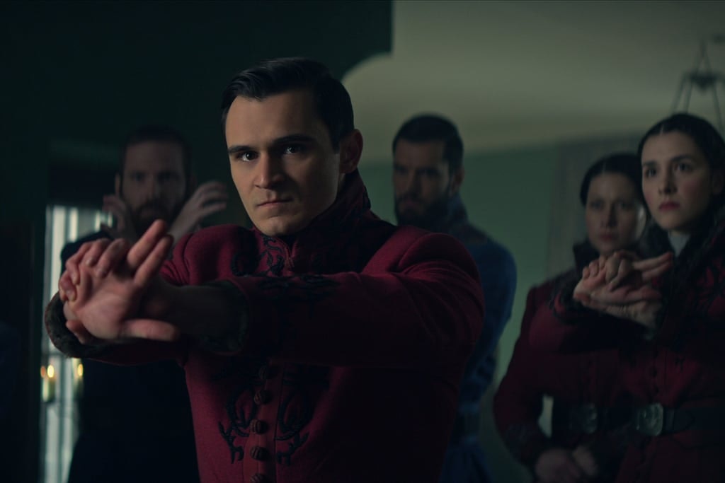 A group of characters in maroon shirts looking very seriously at someone off camera
