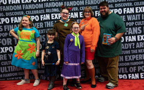 a family cosplaying as the characters from Scooby Doo