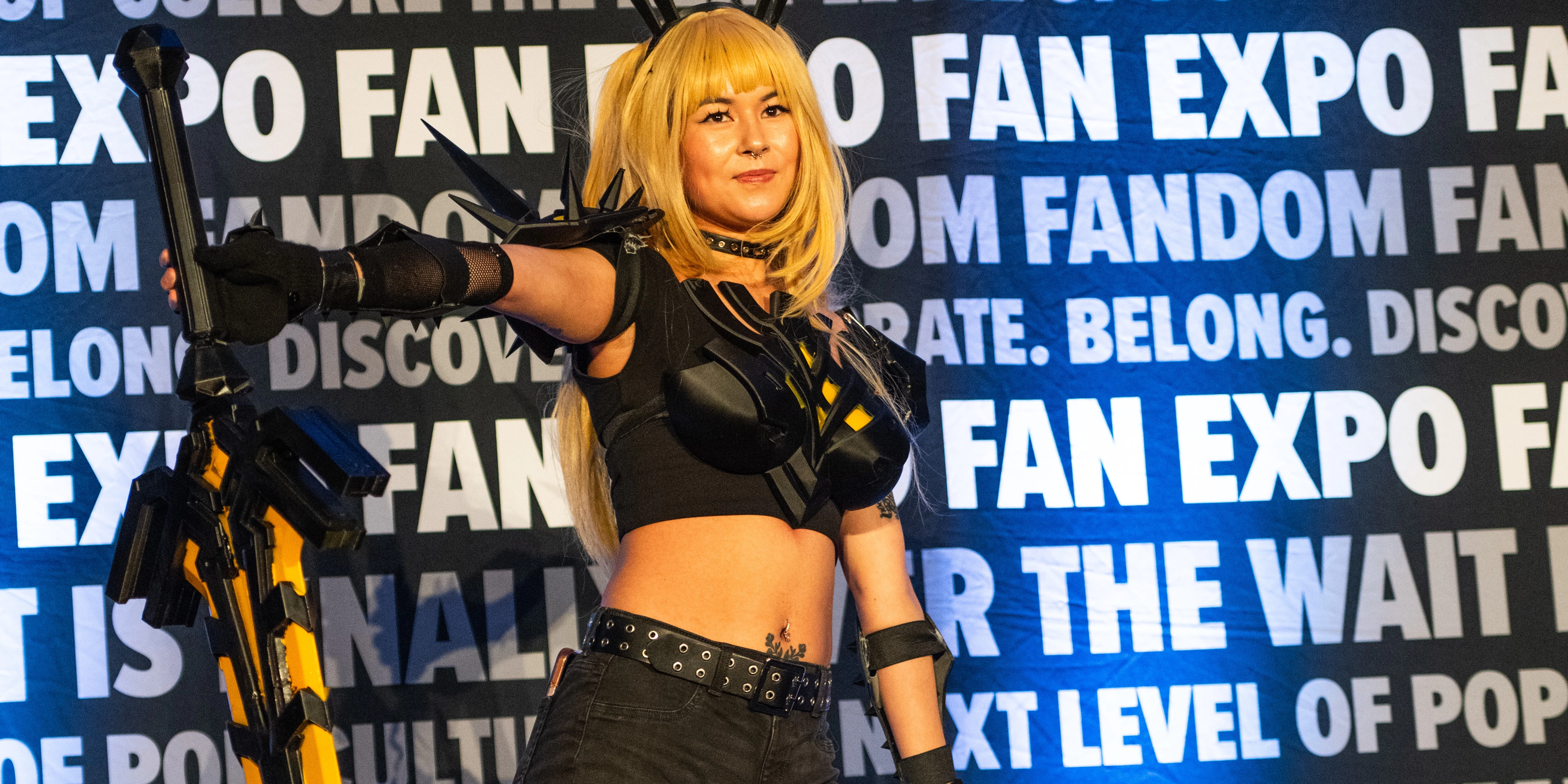 A lineup of cosplay competitors stand on stage during the Cosplay Craftsmanship Cup at FAN EXPO Cleveland. Each participant wears a detailed costume while judges and audience members watch the competition.