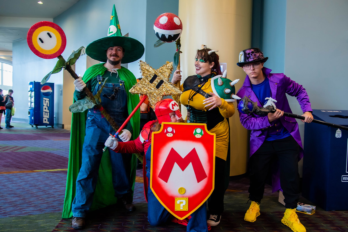 A group of Mario Bros cosplayers dressed as Mario, Luigi, Waluigi, & Bowser