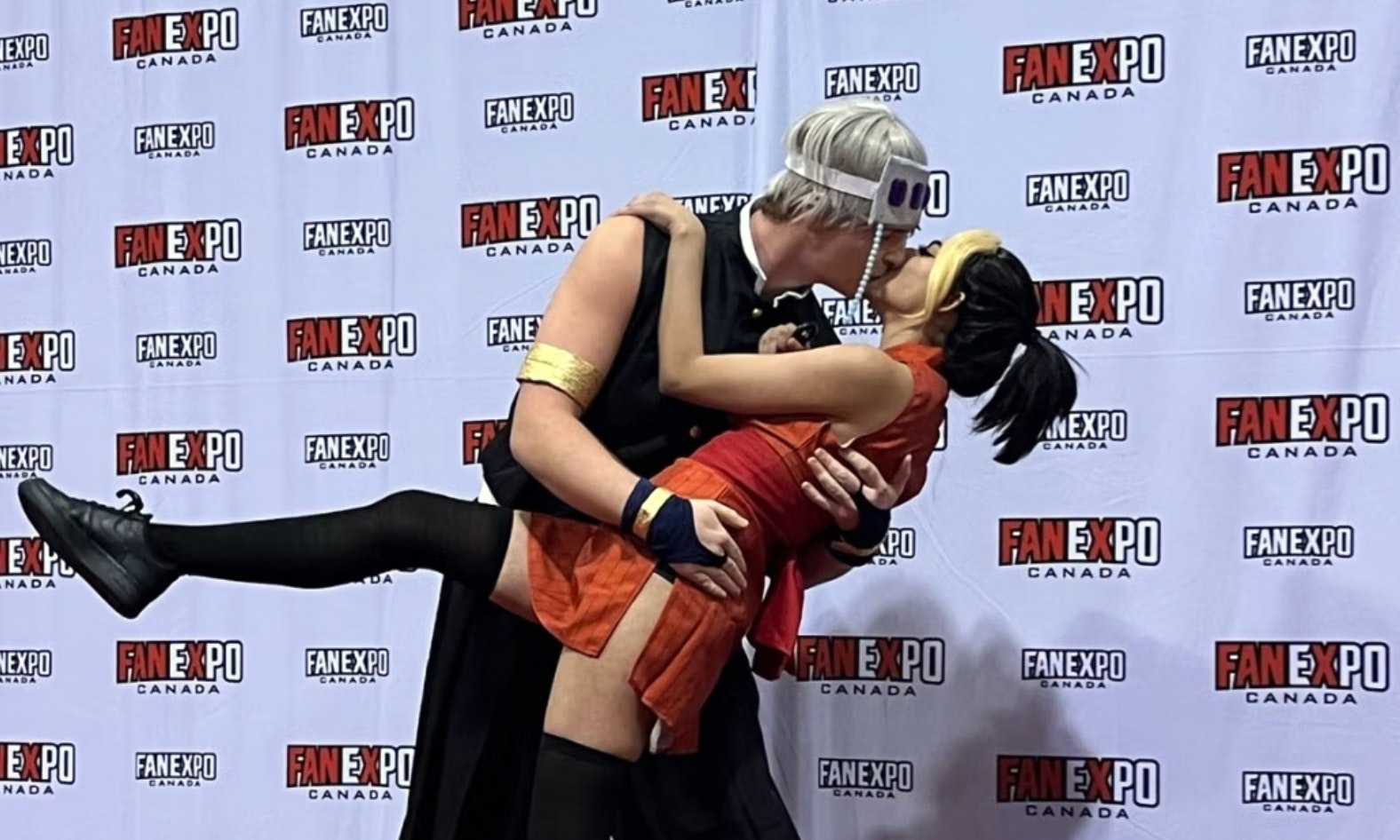Two cosplayers kiss on the red carpet