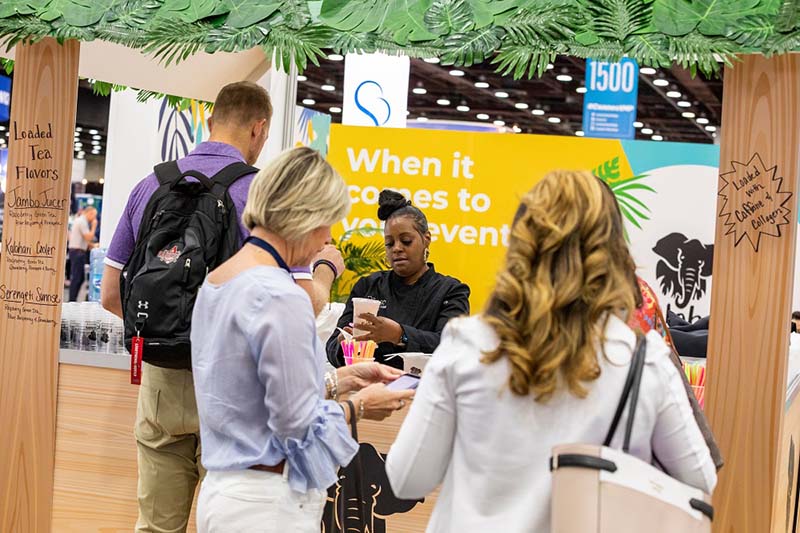 Men and women conversating on a trade show floor.