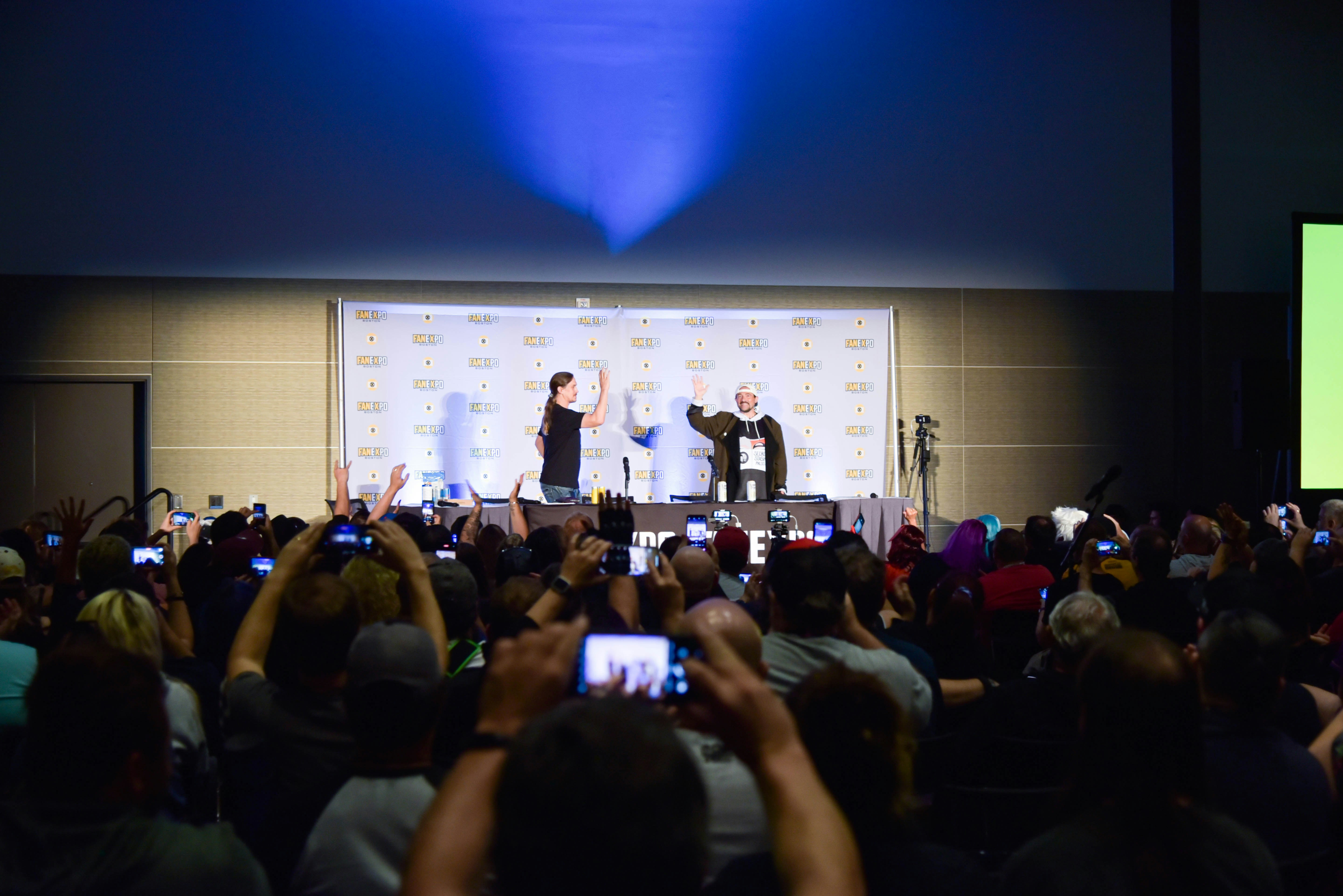 Jay Mewes and Kevin Smith waving at the excited crowd at the start of their special event.