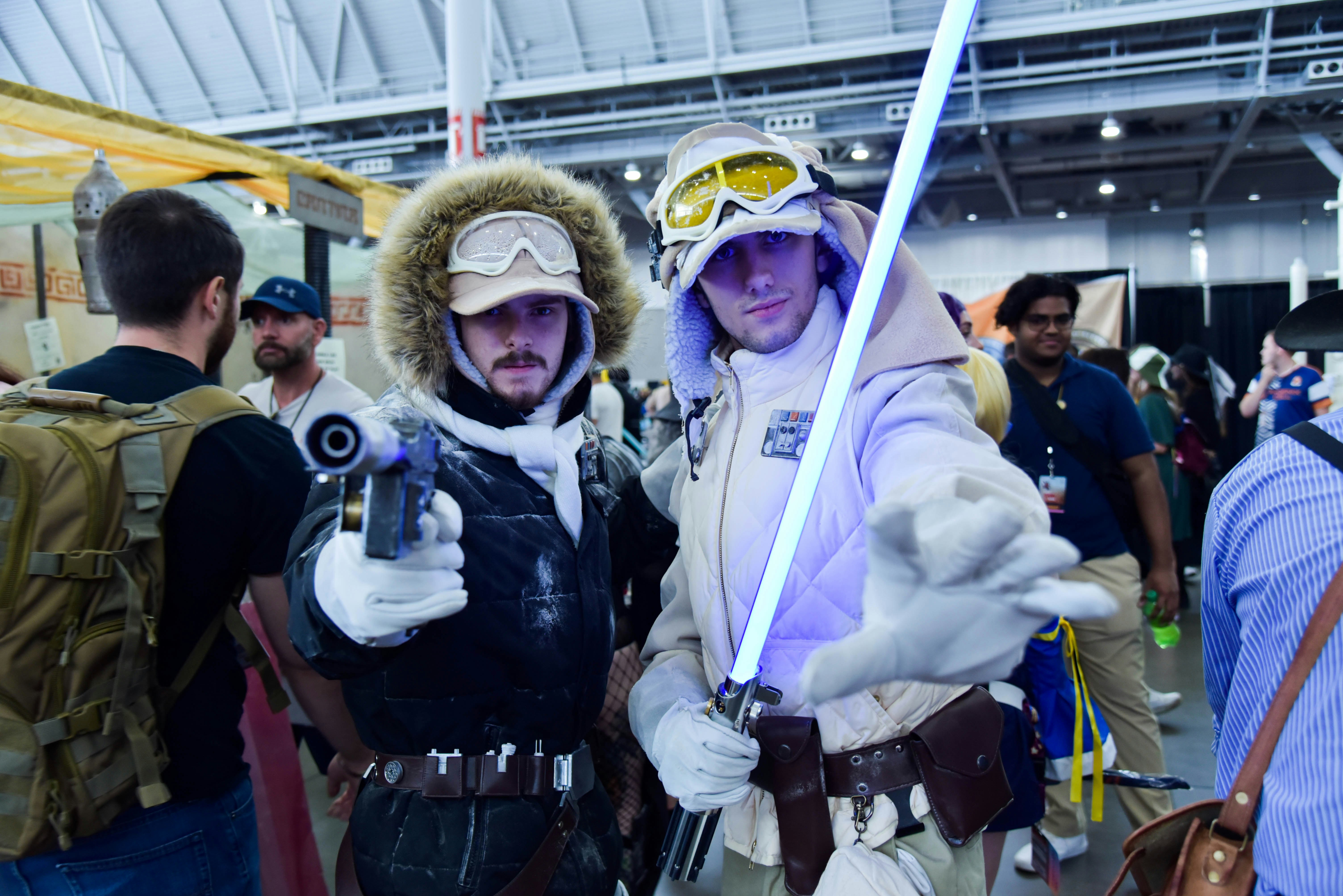 Two cosplayers, from left to right, dressed up as Han Solo and Luke Skywalker from Star Wars Episode V: The Empire Strikes Back.