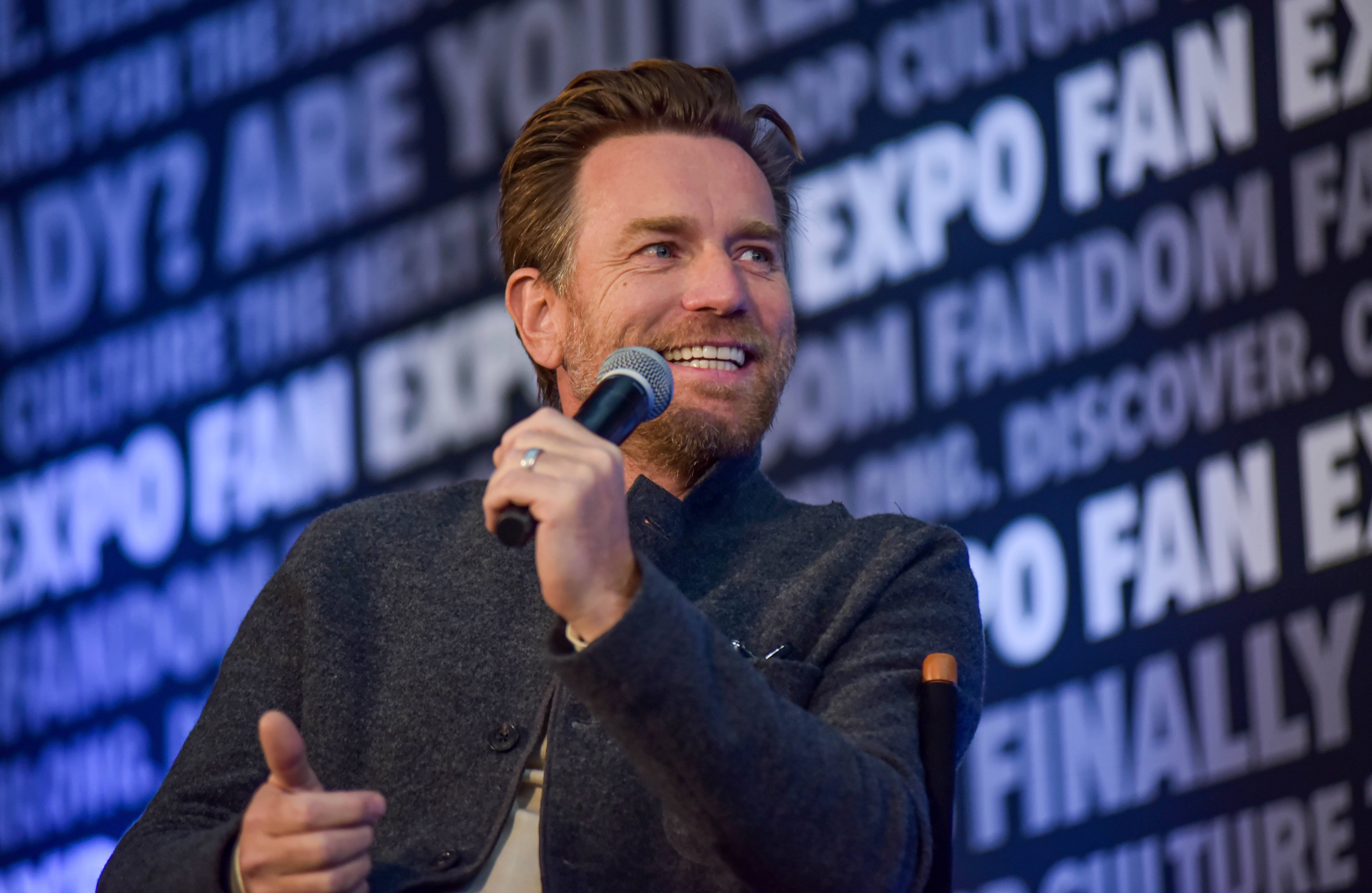 Ewan McGregor smiling as he speaks into a microphone during his Sunday panel.