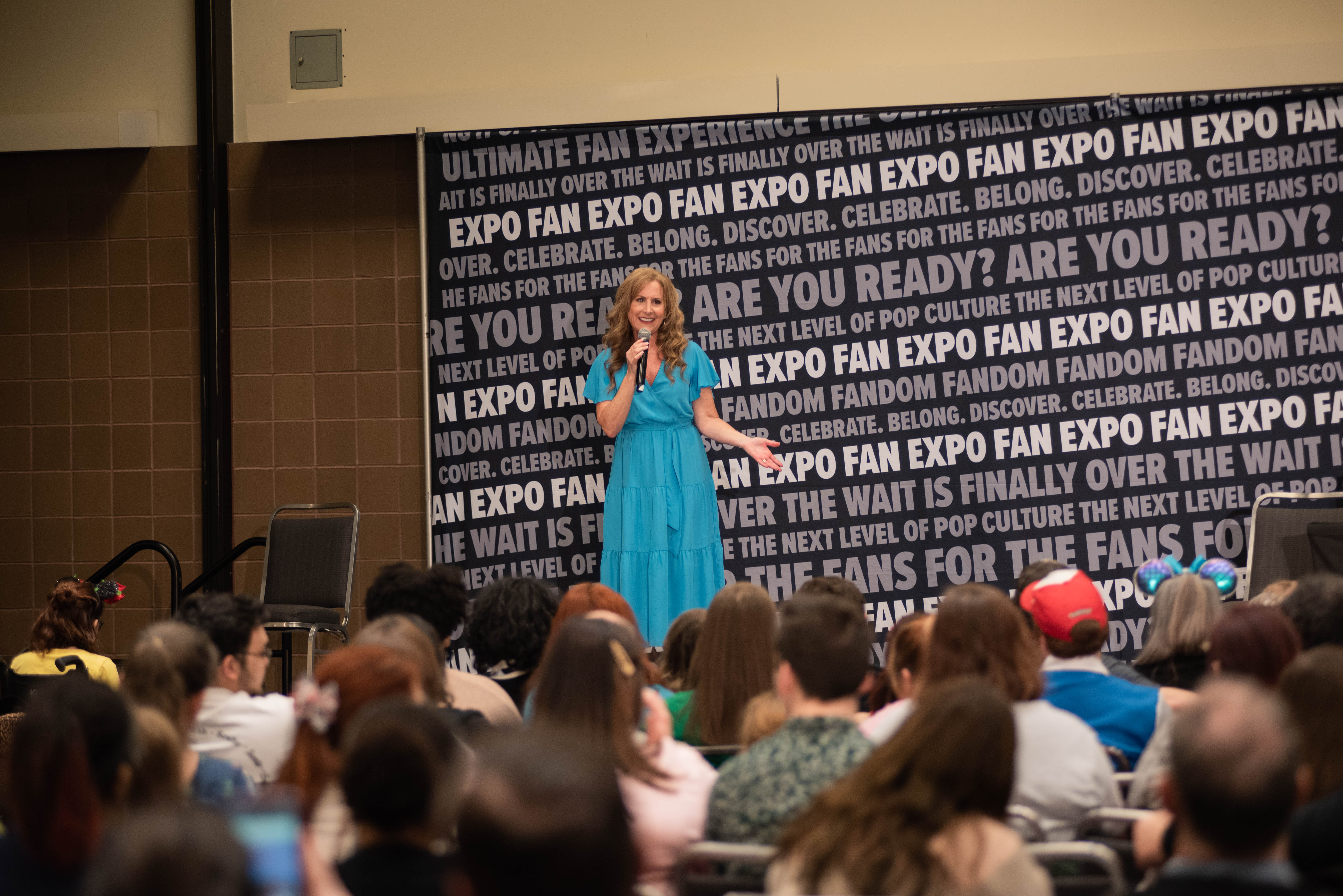 Jodi Benson addressing the crowd at her panel before she starts singing.