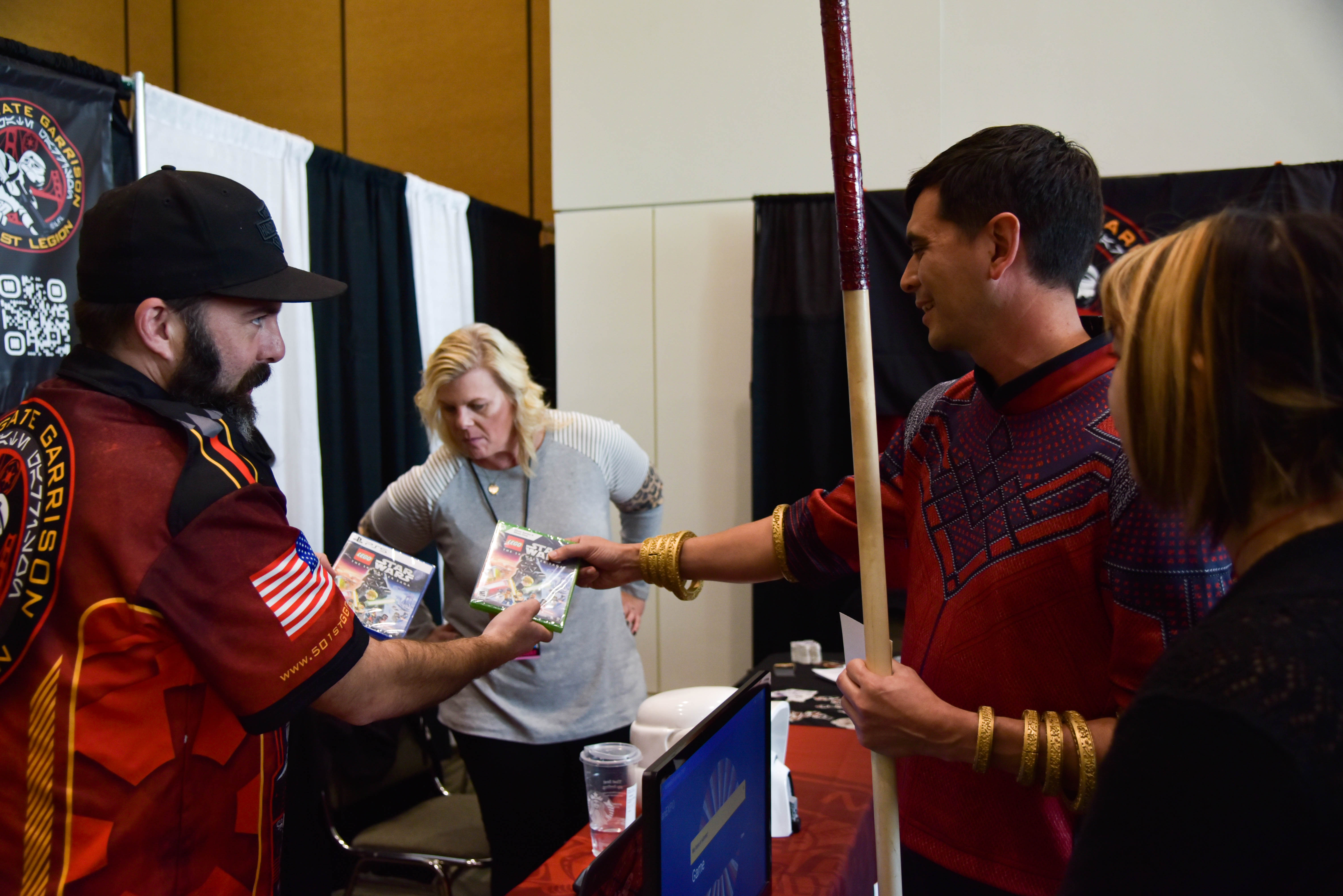 Shang Chi cosplayer interacting with 501st member as they are holding a Lego Star Wars game