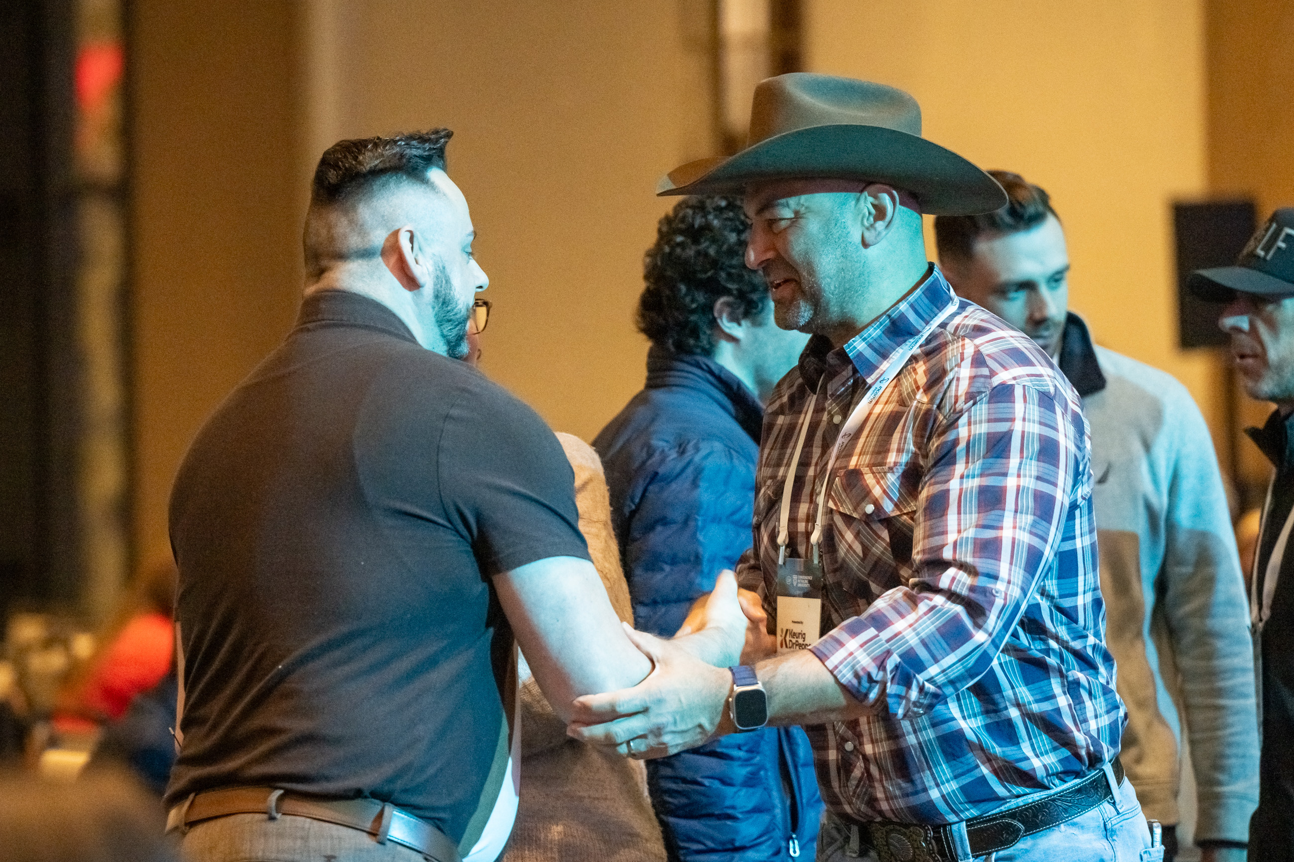 Image of attendees from 2024 CRU conference shaking hands.