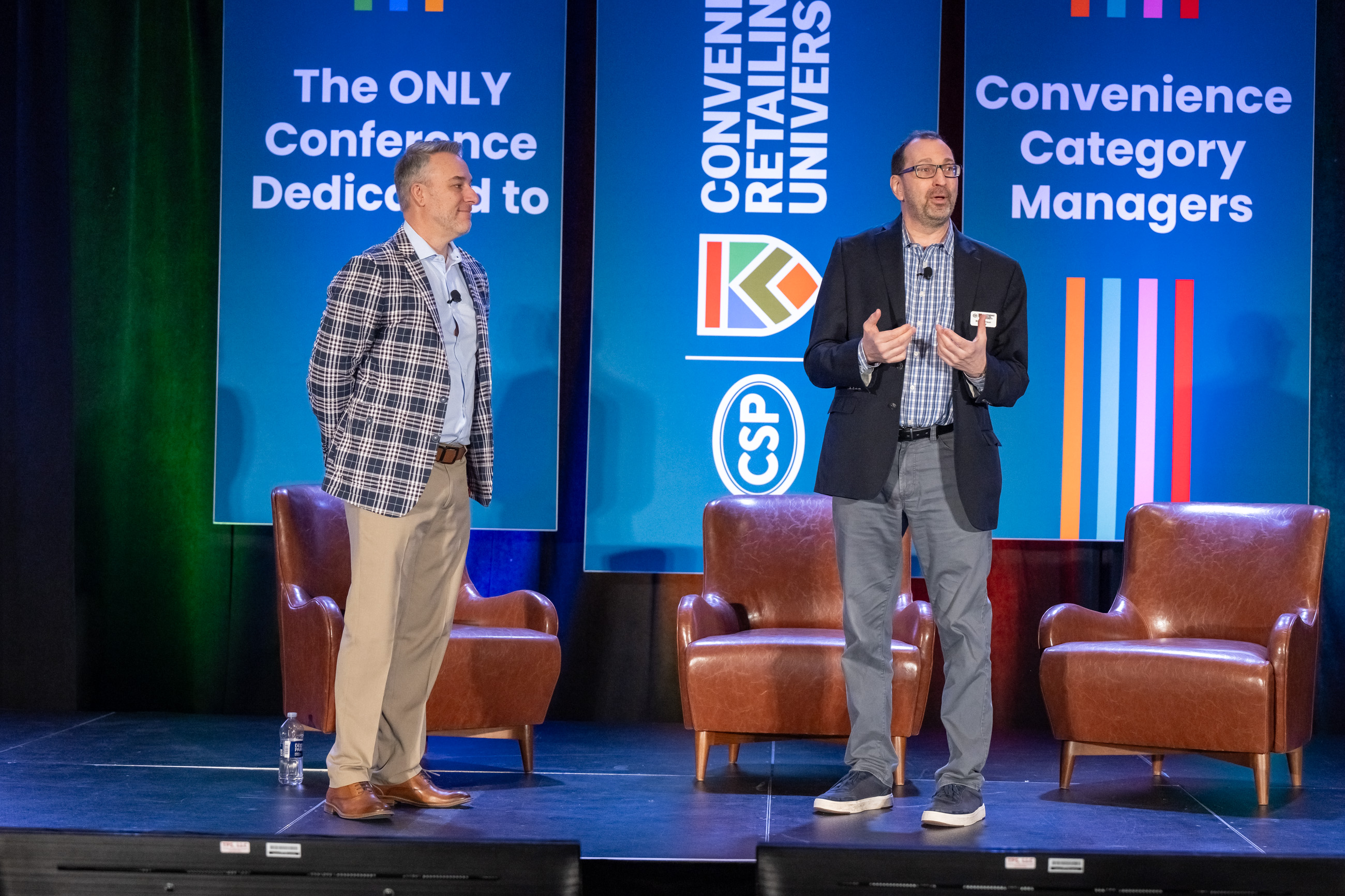 Image of two speakers on the general session stage at the 2024 CRU conference.