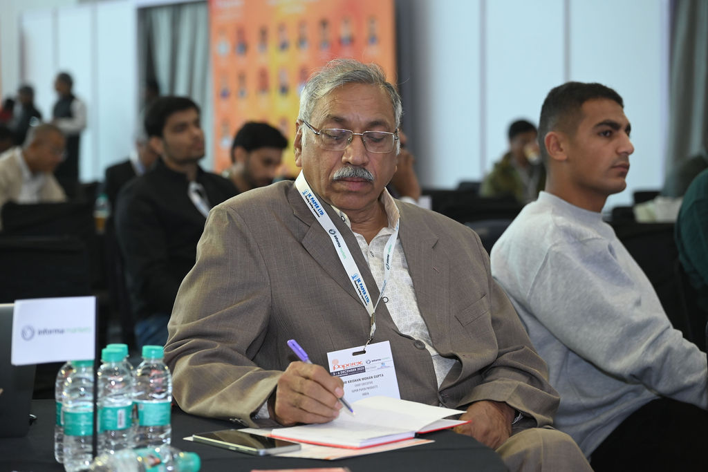 Man speaking with microphone at a conference or business event