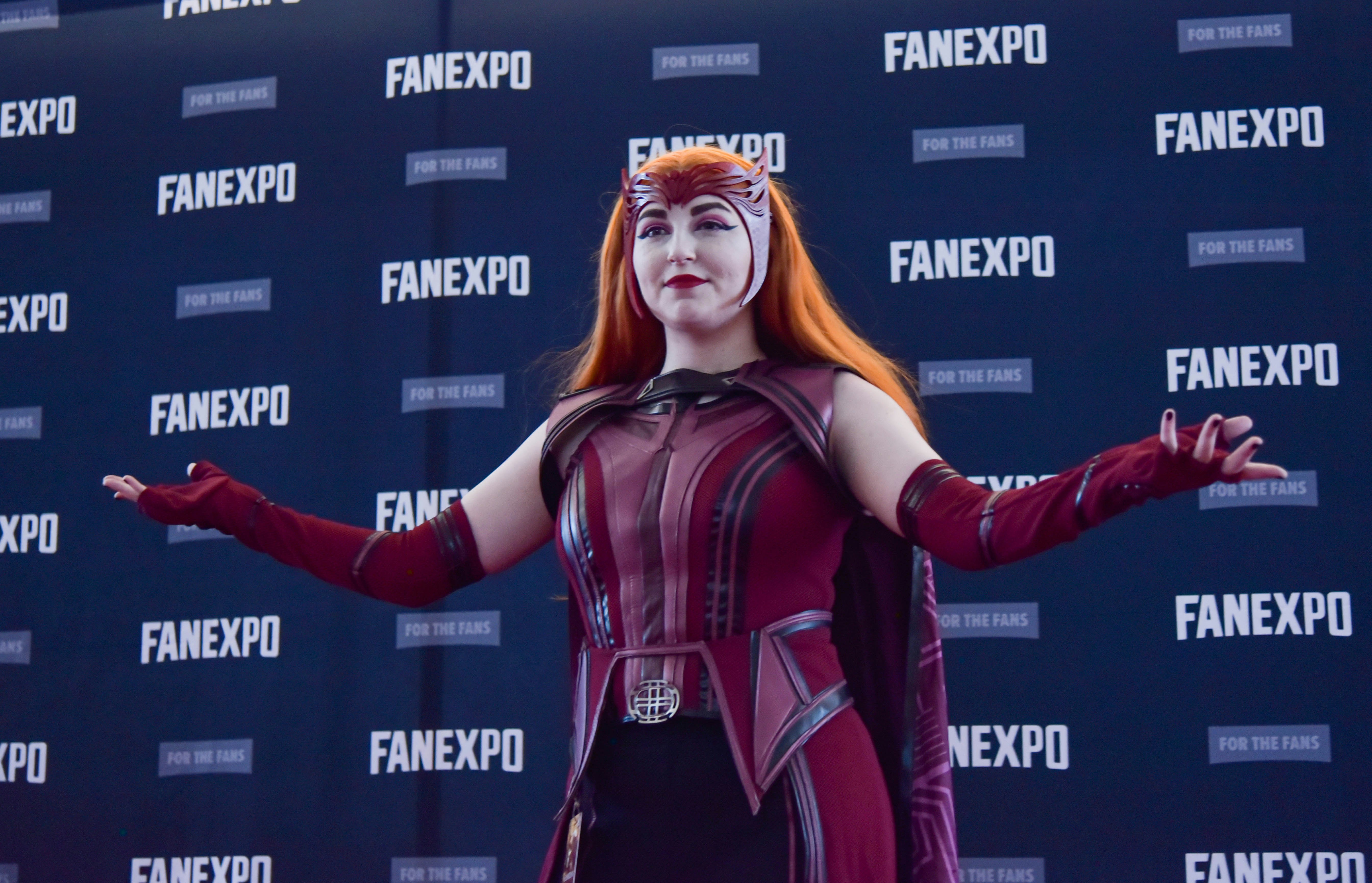 A cosplayer on the Cosplay Red Carpet dressed up as Wanda Maximoff in WandaVision from the Marvel Cinematic Universe.