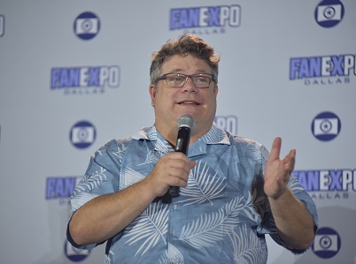 Sean Astin holding a microphone