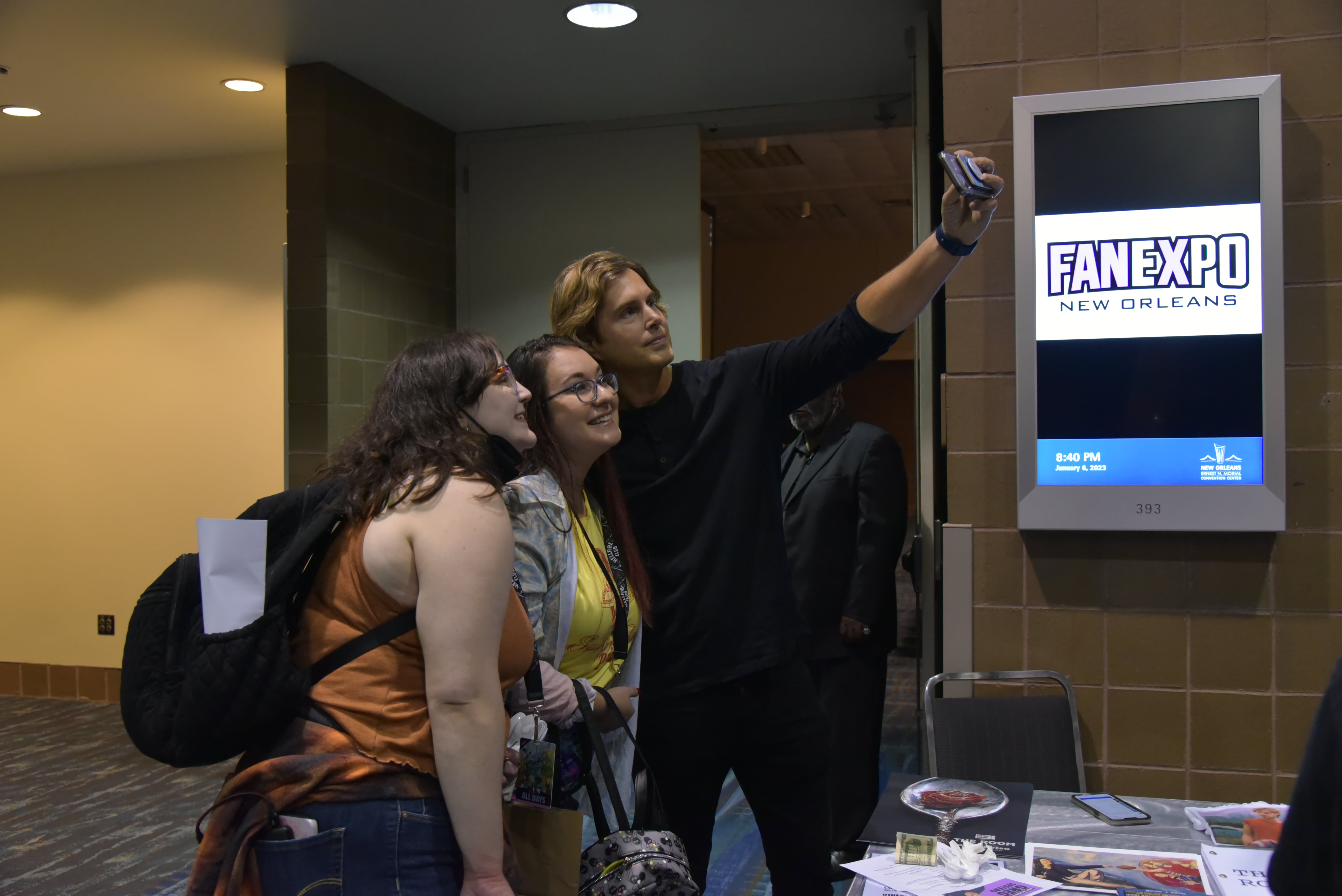 Greg Sestero takes a selfie with two of his fans.
