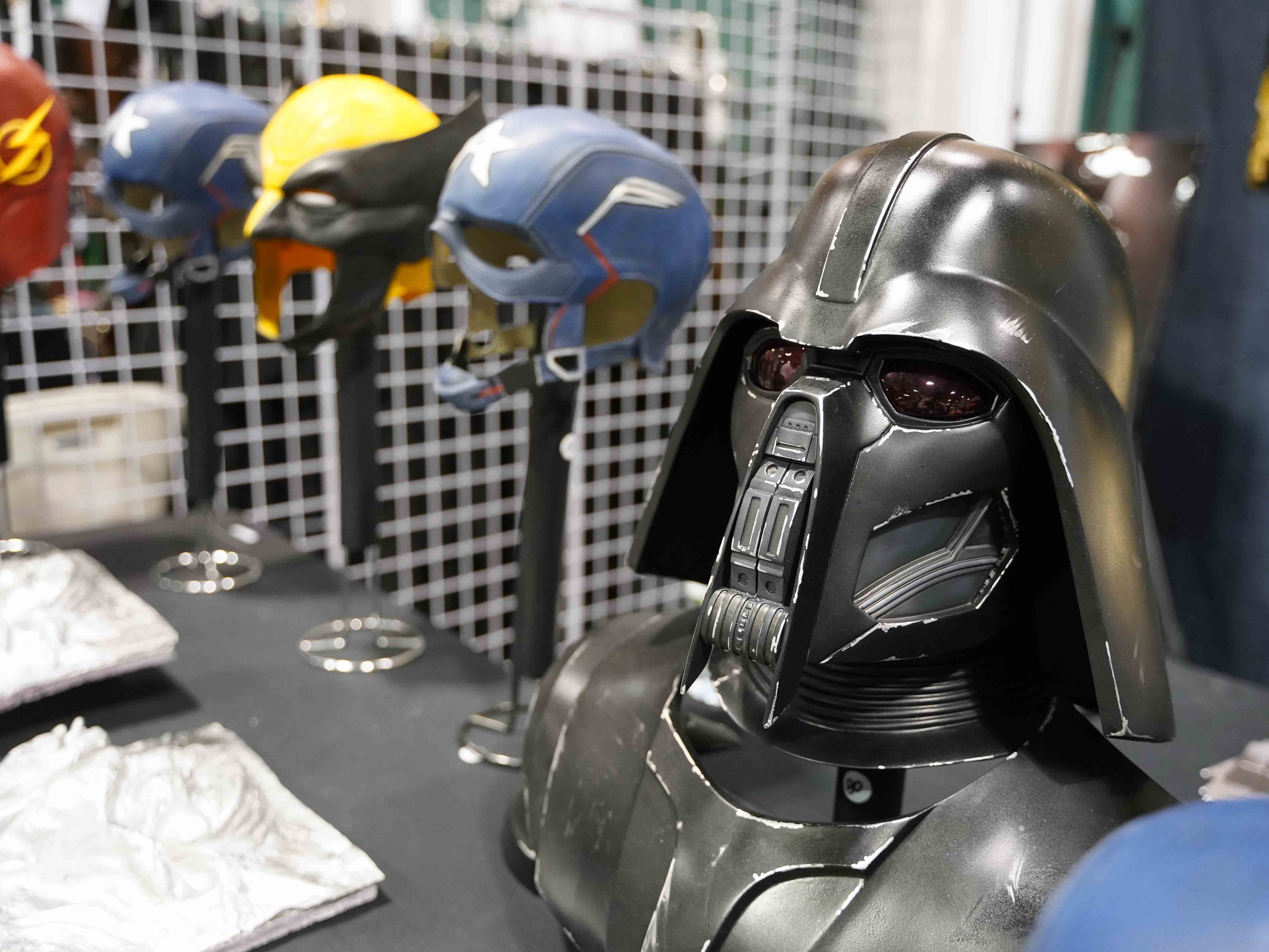 Star Wars helmets lined up on a table from an exhibitor