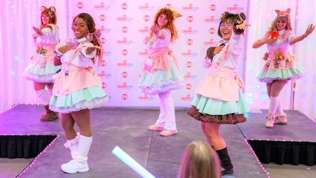 Maids are dancing onstage during a Maid Cafe event