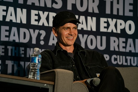 Hayden Christensen sitting on his panel, smiling