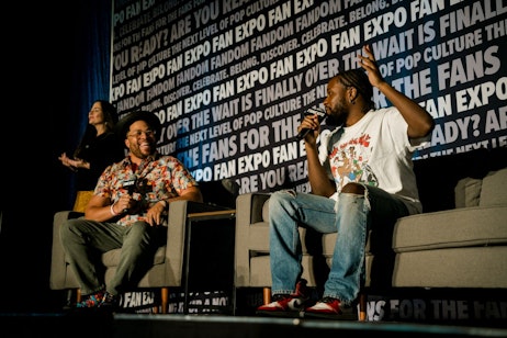 Shameik Moore on his panel while his moderator is laughing