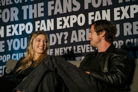 Grace Van Dien and Jospeh Quin on their panel, smiling at each other