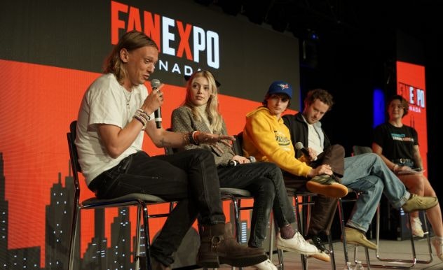 Jamie Campbell Bower, Grace Van Dien, Finn Wolfhard and Joseph Quinn are sitting on stage next to each other for their panel at FAN EXPO Canada.