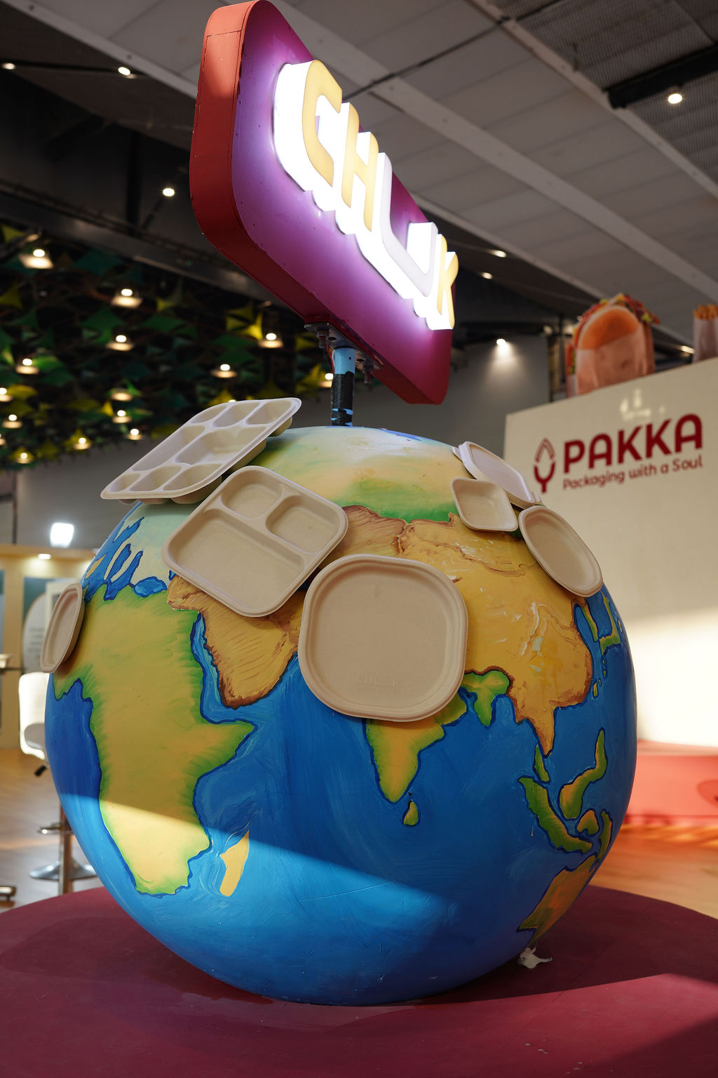 Attendees gathered around an exhibition booth at the Paperex trade show.