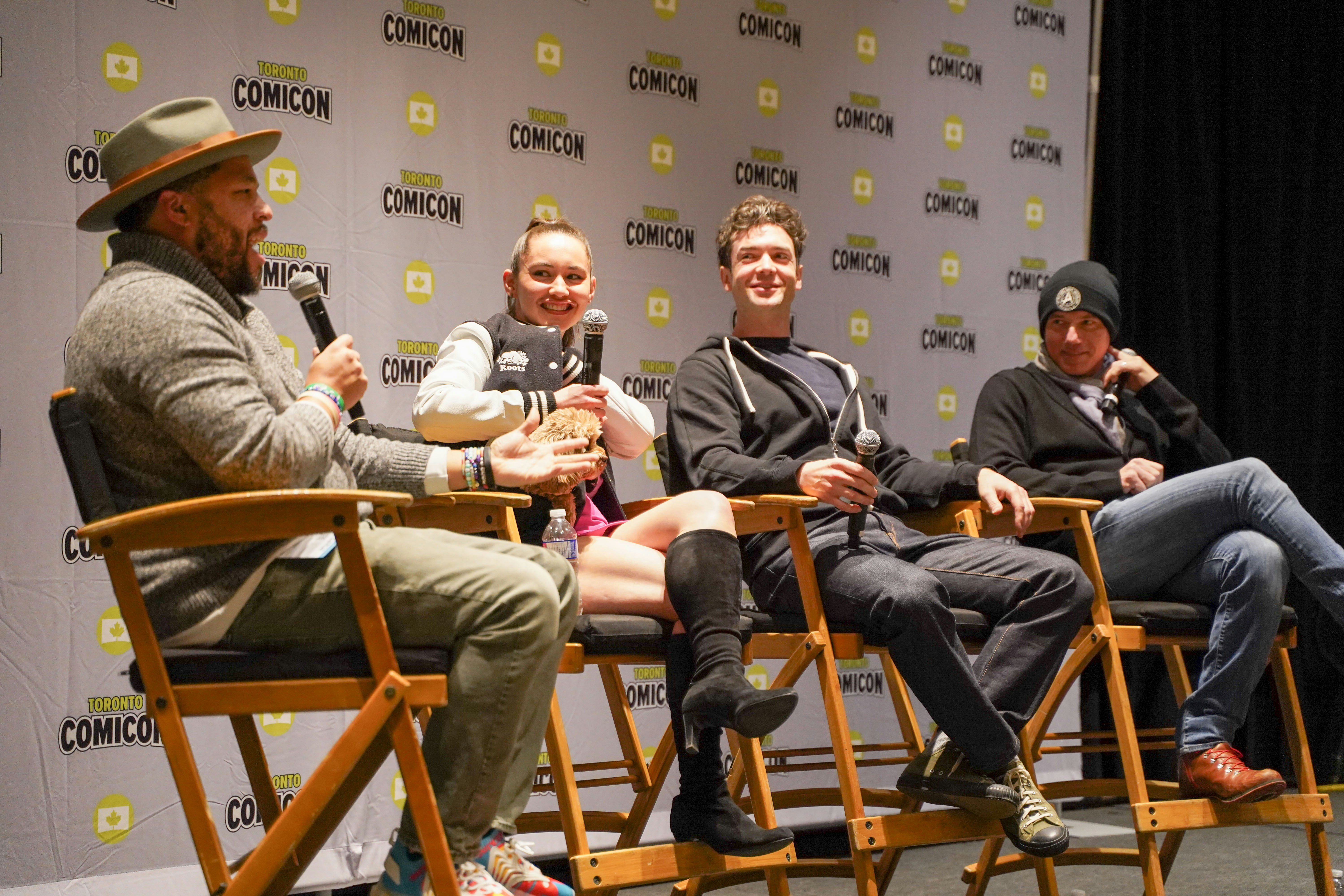 From left to right: Moderator, Christina Chong(and her small, fluffy dog Runa), Ethan Peck, Anson Mount. Our Star Trek stars smile at the moderator as he asks another question