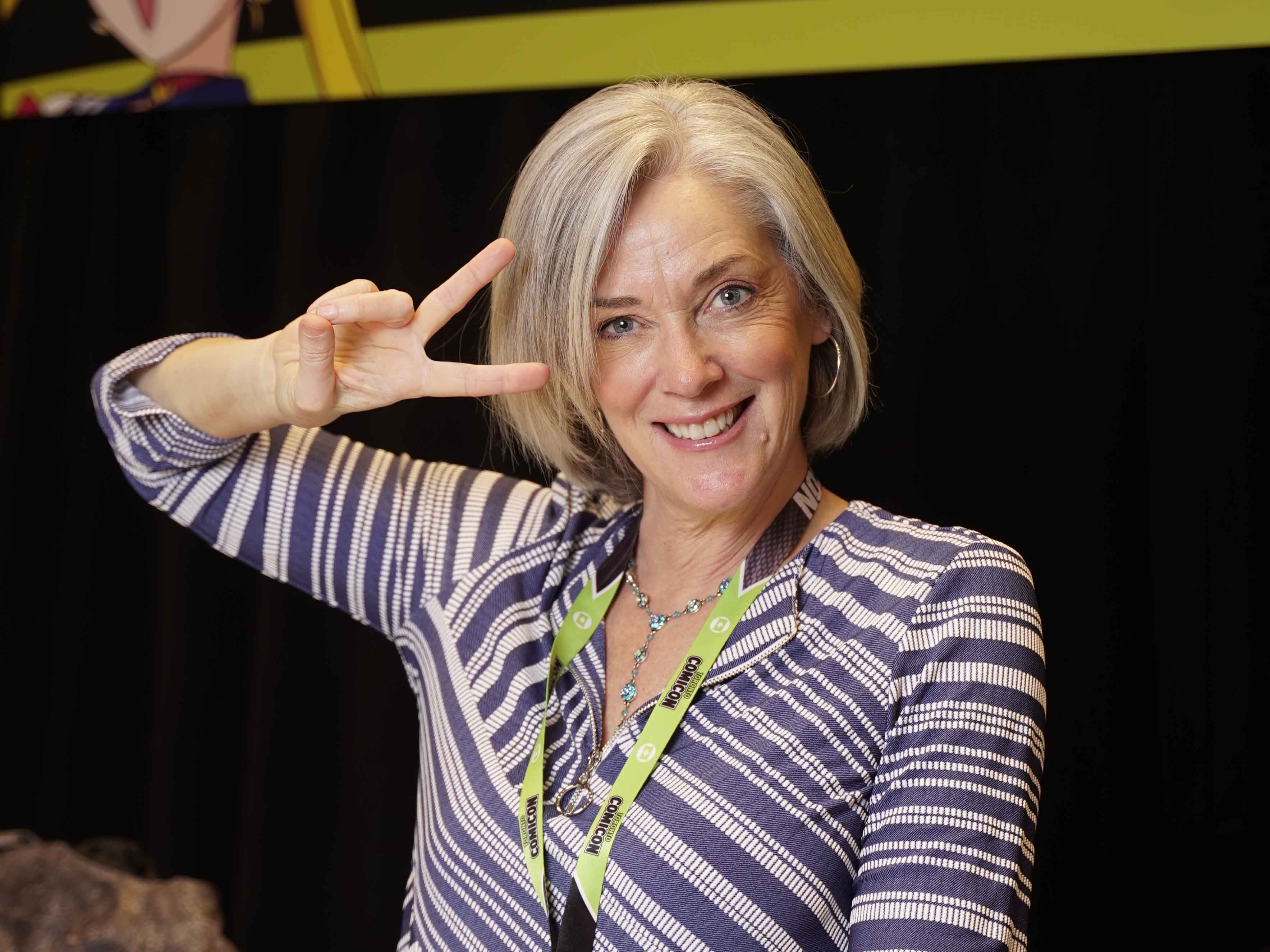 LINDA BALLANTYNE giving a peace sign to the camera