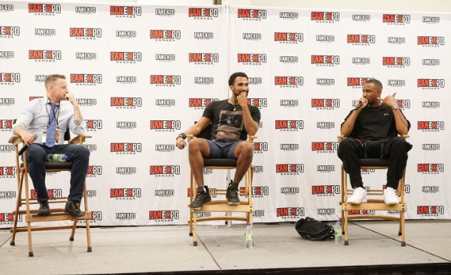 Nathan Mitchell and Jessie Usher sit next to each other on stage at FAN EXPO Canada for their panel