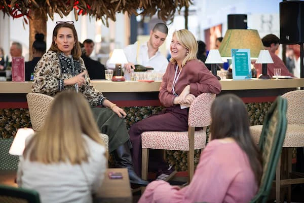two women sitting at the bar laughing