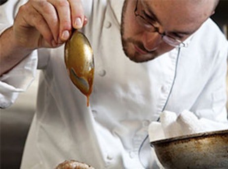 chef saucing a plate