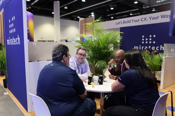 Enterprise Connect Attendees at Table in Expo Hall