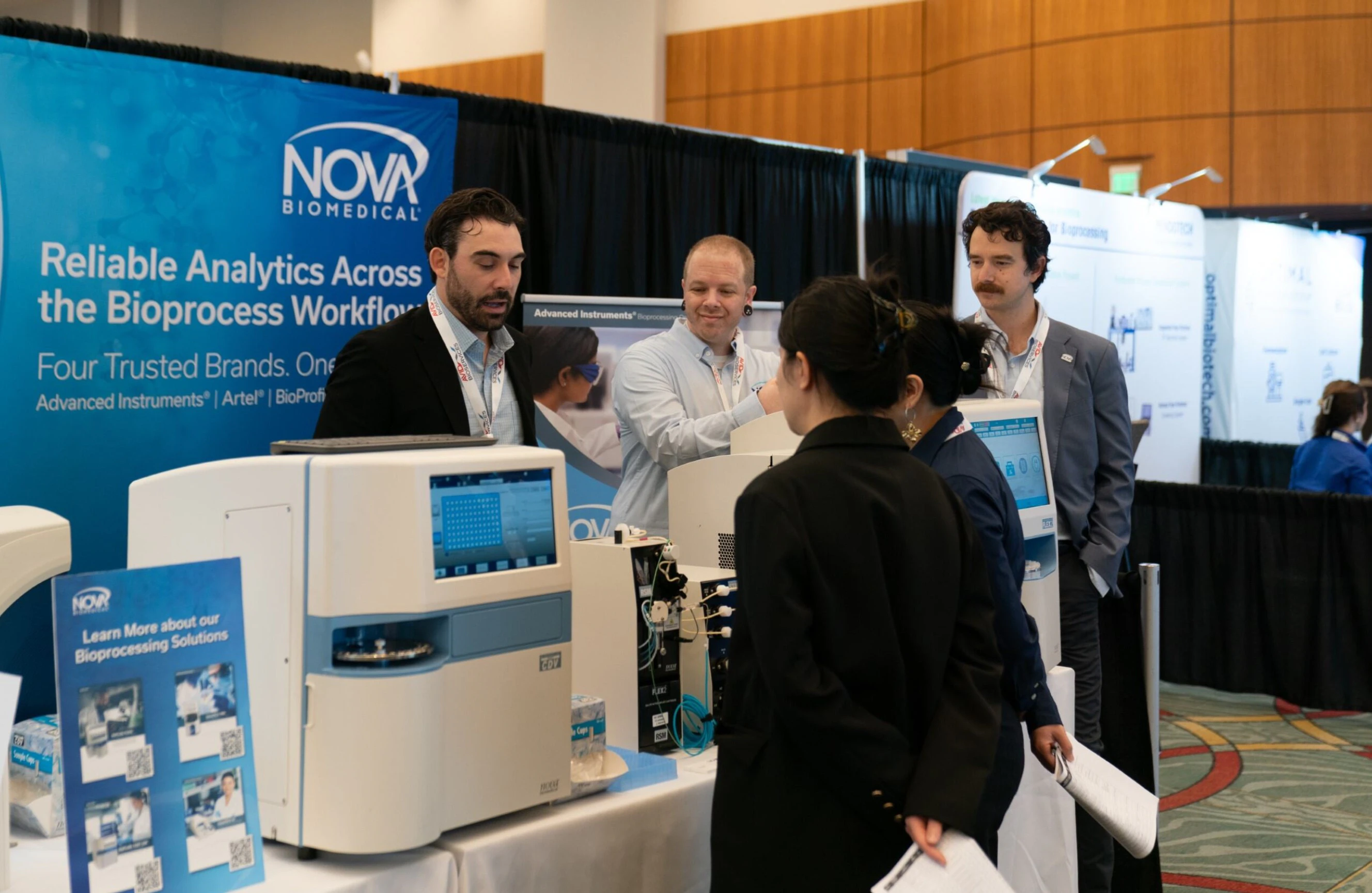 Attendees and exhibitors laughing in the exhibition hall at BPI West