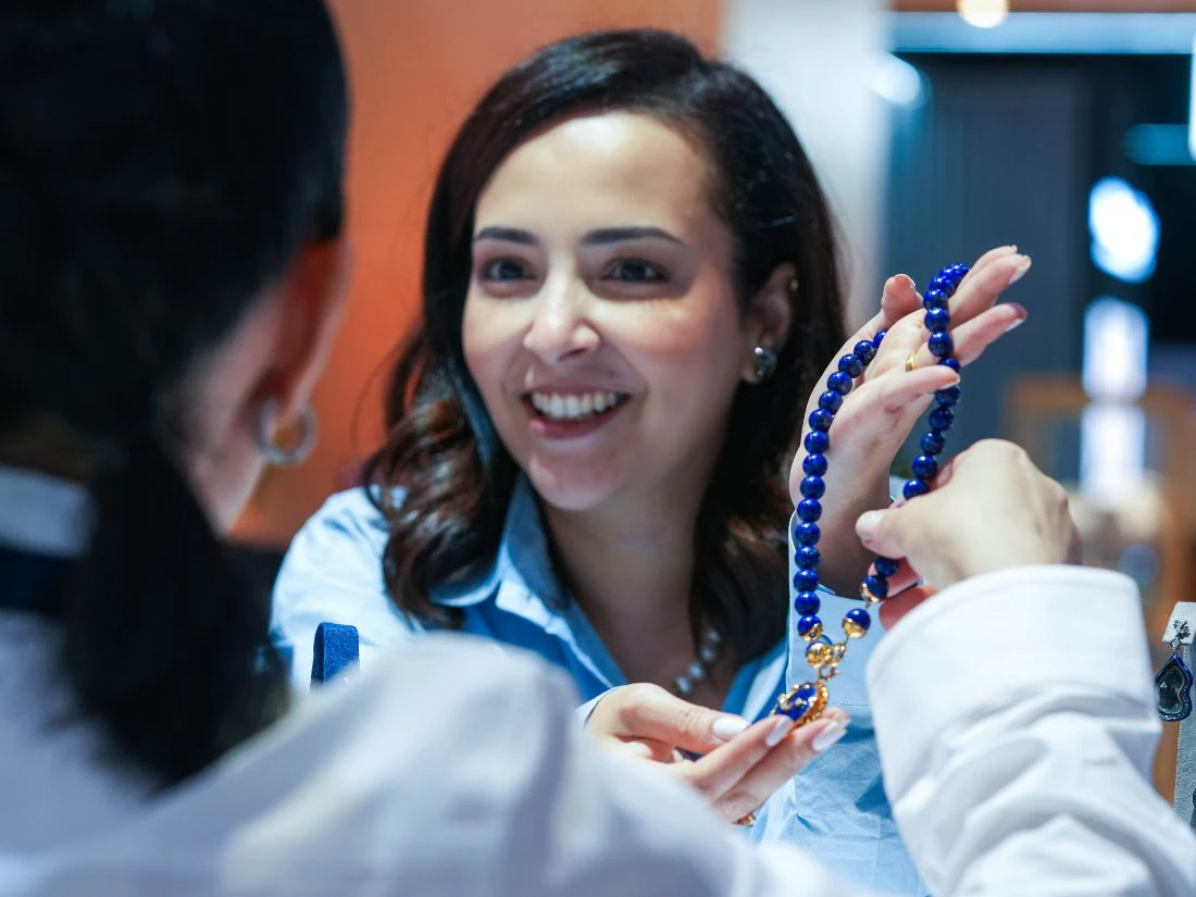 jeweller showing their necklace