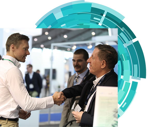 Two men engaged in a handshake at an exhibition