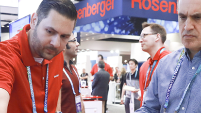 An exhibitor showing his product to an attendee