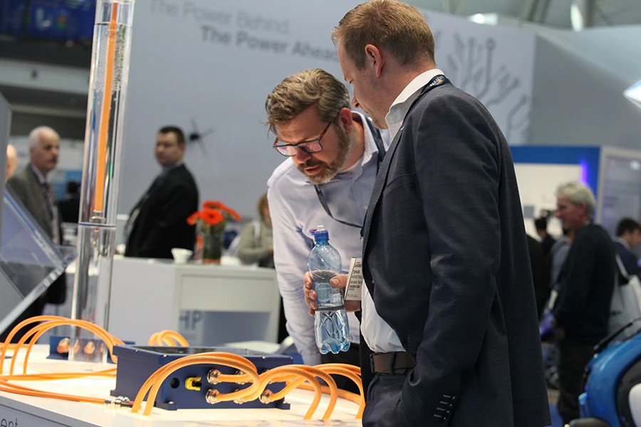 Two men standing side-by-side at an exhibit display.